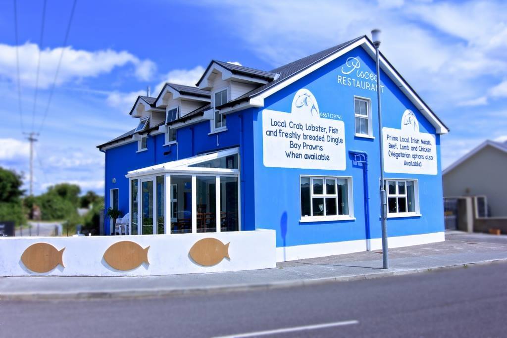 Pisces Restaurant — bright blue building on Strand Road, Castlegregory